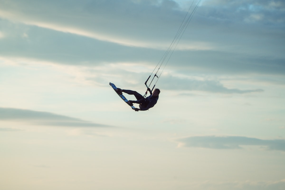 Kitesurfer jumping high above the ocean