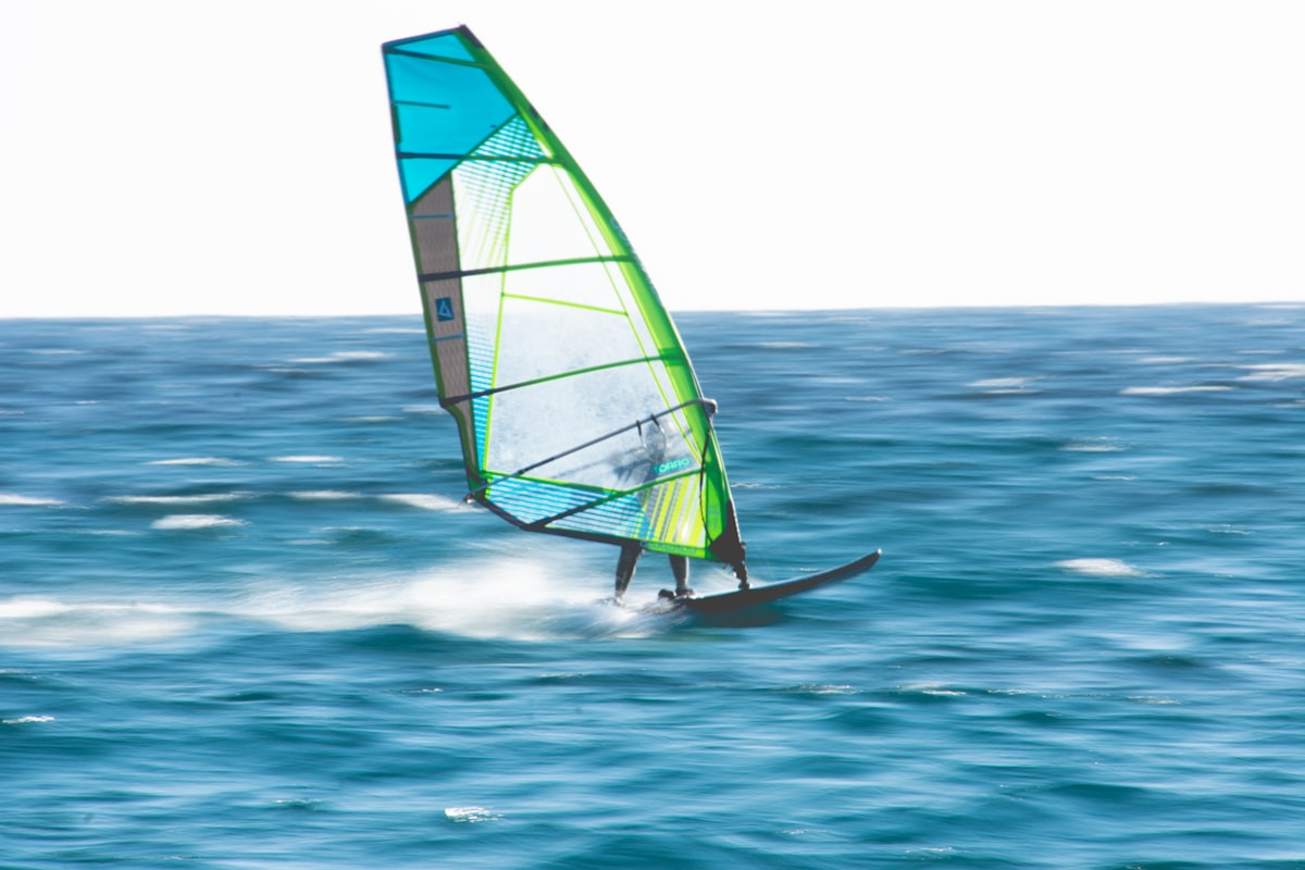 Windsurfer speeding across turquoise water